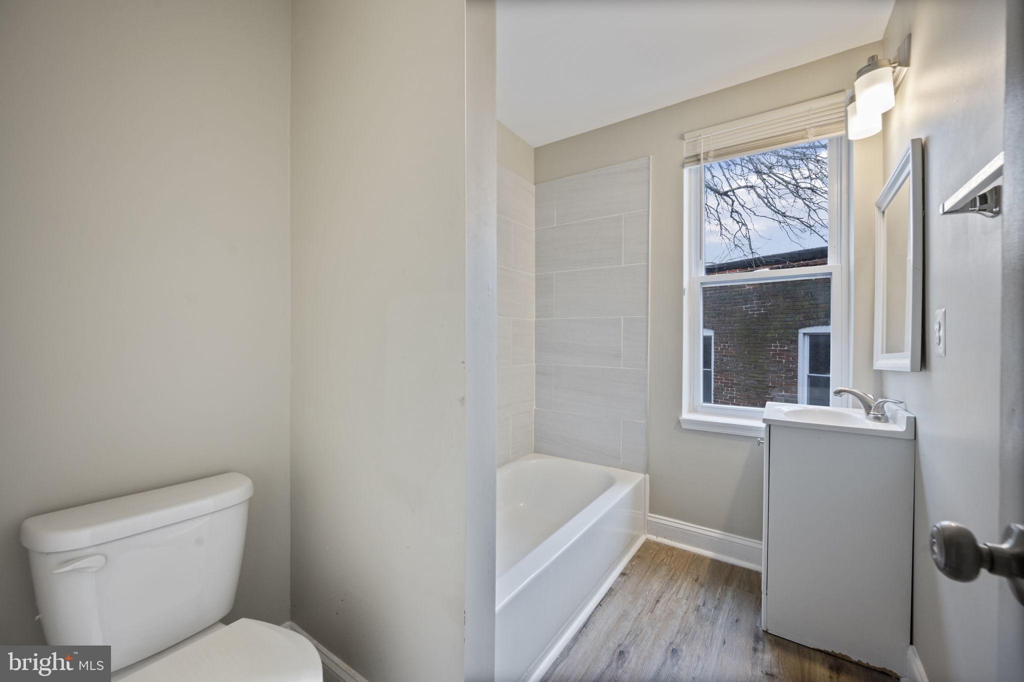 3619 Cottage Avenue Baltimore, MD 21215 - Photo 26 of 31 a bathroom with a toilet a sink and bathtub