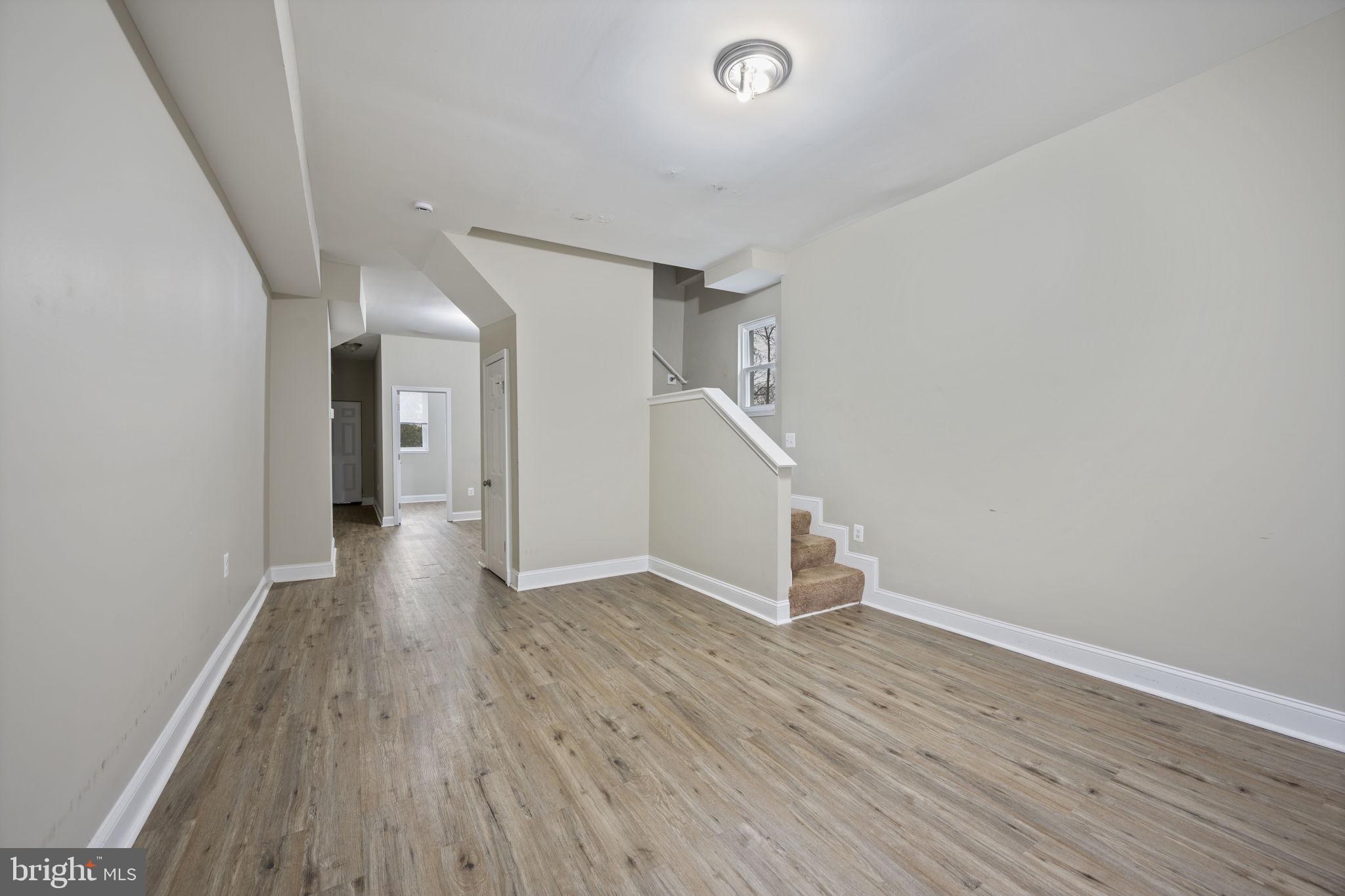3619 Cottage Avenue Baltimore, MD 21215 - Photo 6 of 31 wooden floor in an empty room with a window