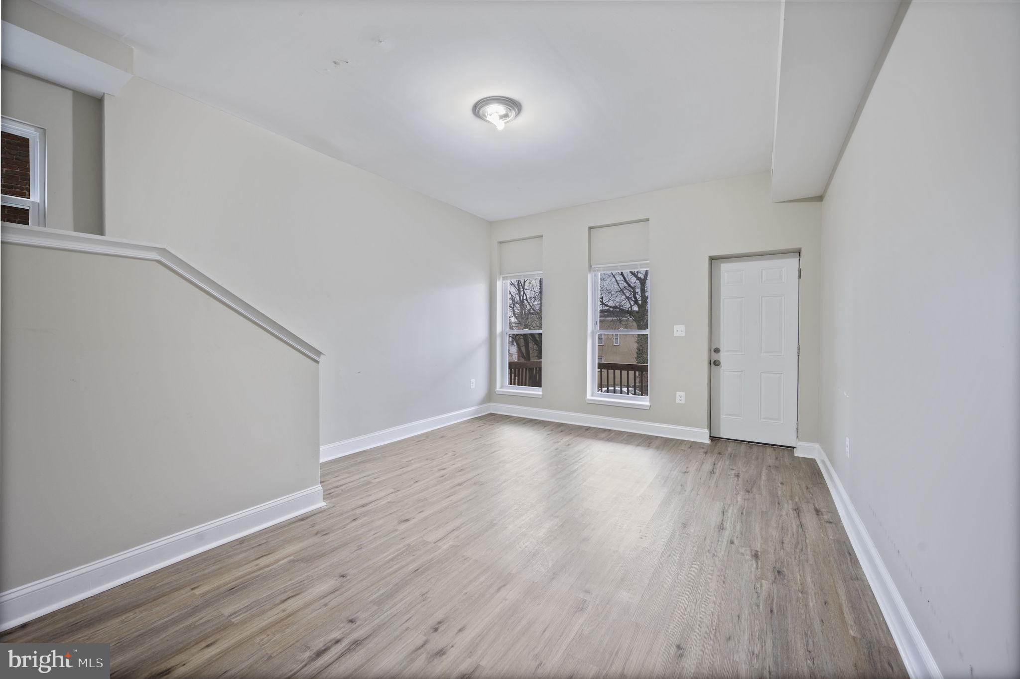 3619 Cottage Avenue Baltimore, MD 21215 - Photo 7 of 31 wooden floor in an empty room with a window