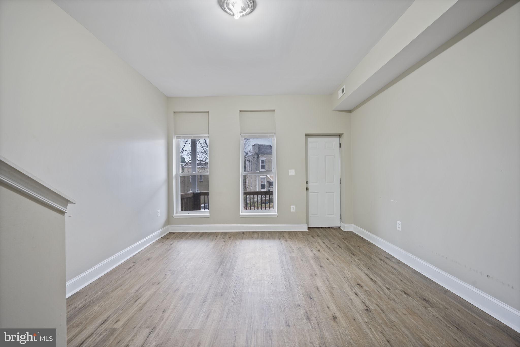 3619 Cottage Avenue Baltimore, MD 21215 - Photo 8 of 31 wooden floor in an empty room with a window