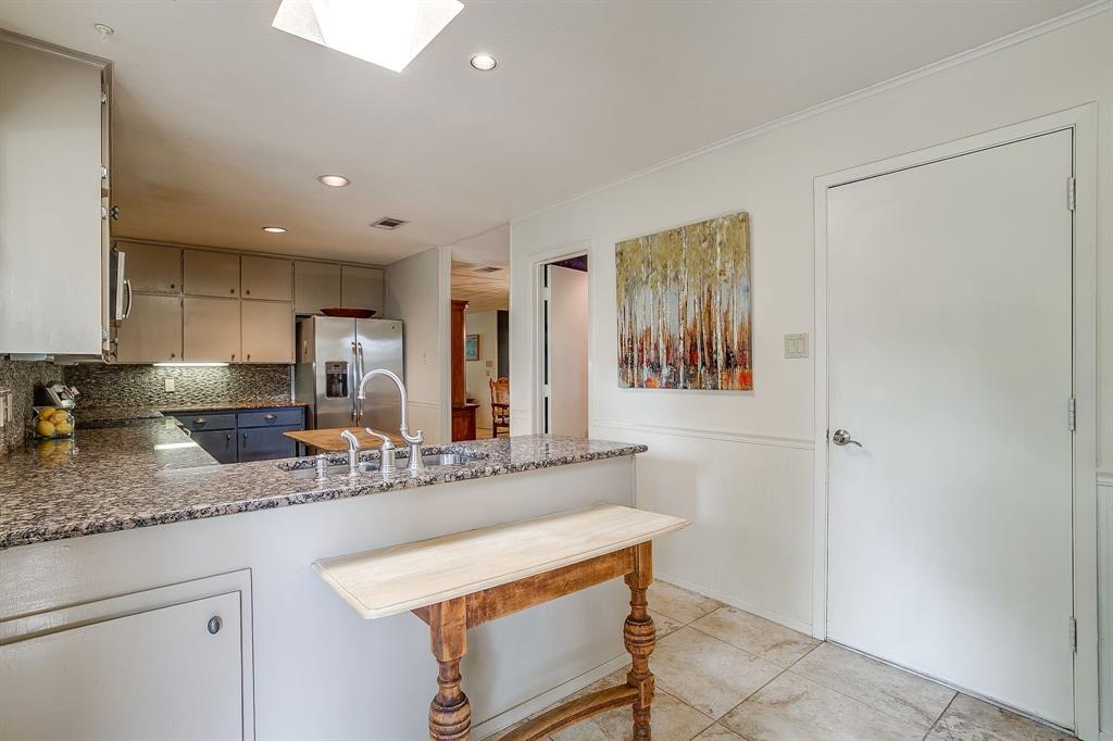 8918 Bellechase Road Granbury, TX 76049 - Photo 14 of 38 a kitchen with stainless steel appliances granite countertop a sink and a refrigerator