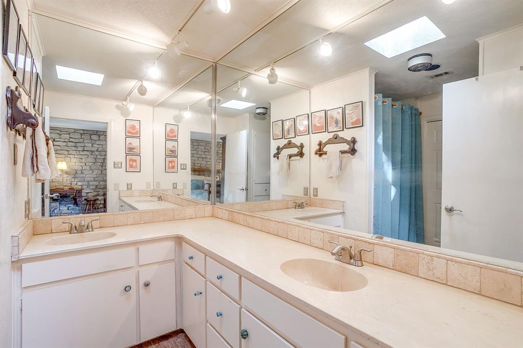 8918 Bellechase Road Granbury, TX 76049 - Photo 24 of 38 a bathroom with a sink double vanity shower and a mirror