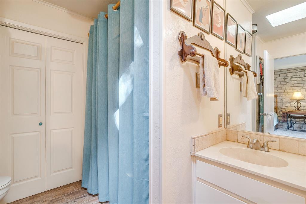 8918 Bellechase Road Granbury, TX 76049 - Photo 25 of 38 a bathroom with a sink and a mirror