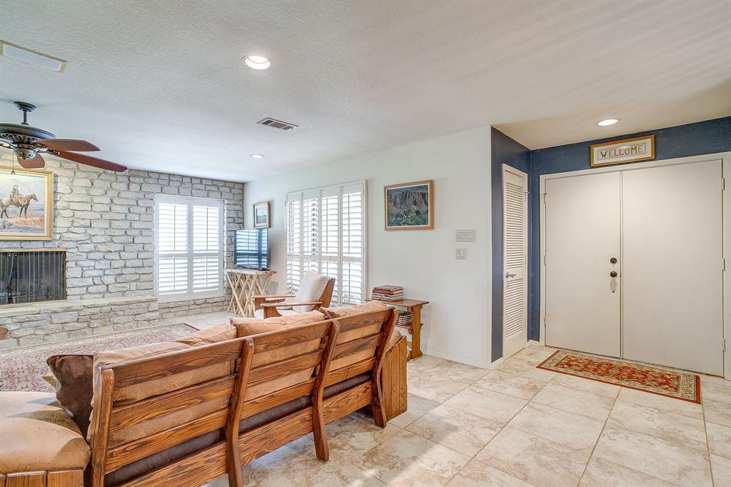 8918 Bellechase Road Granbury, TX 76049 - Photo 5 of 38 a living room with furniture and a fireplace