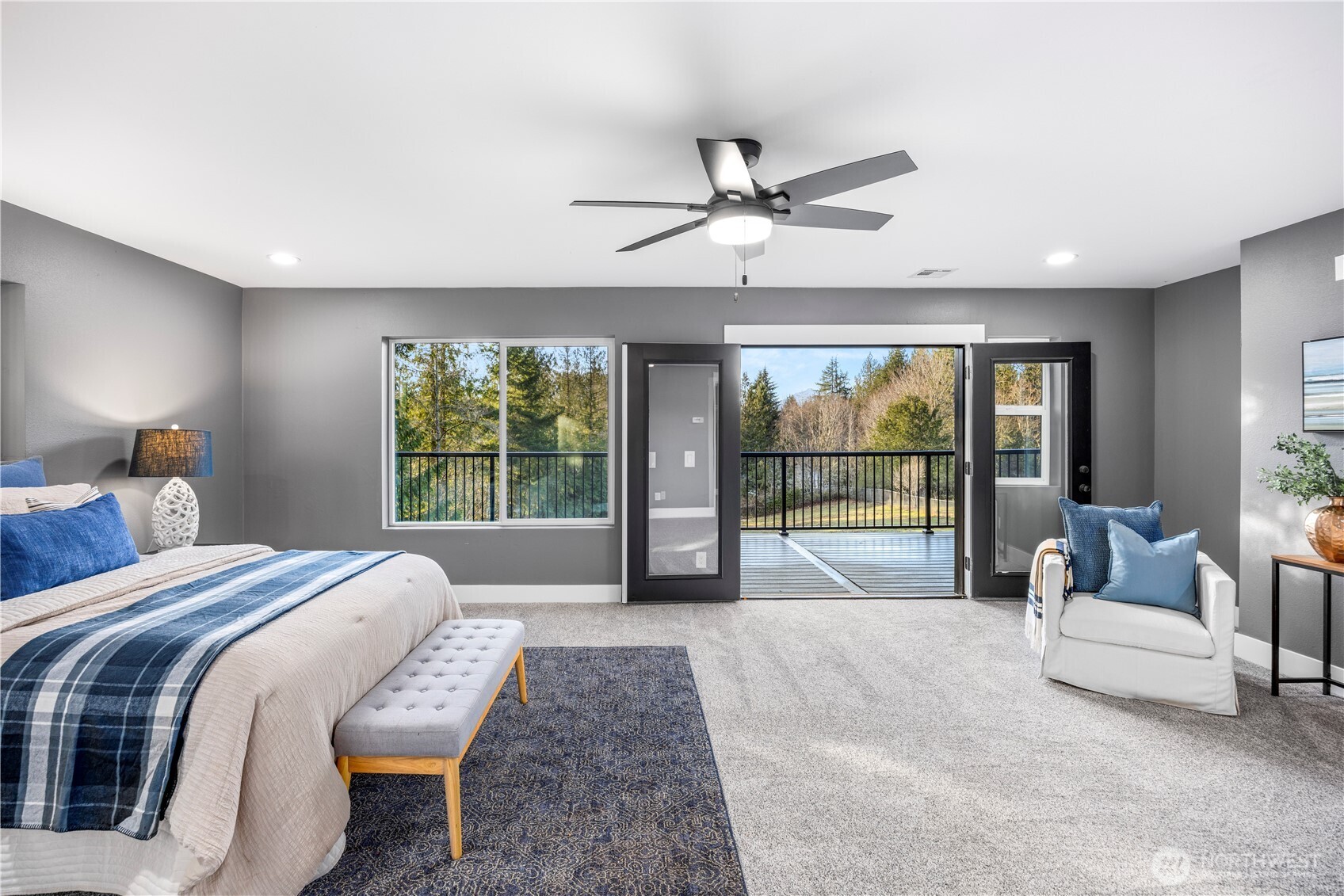 9371 Willamette Meridian Road Northwest Silverdale, WA 98383 - Photo 24 of 40 a spacious bedroom with a large bed and a large window