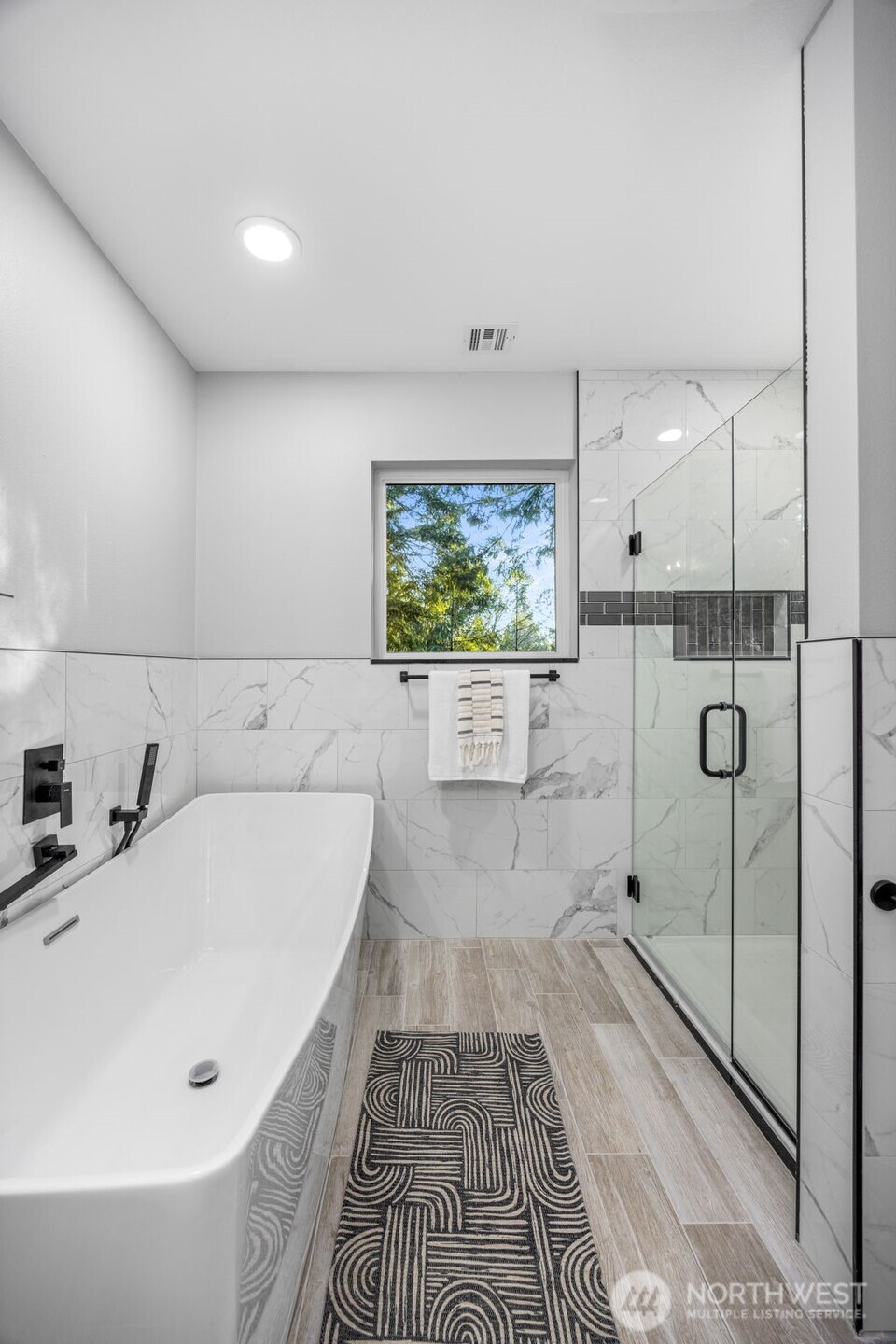 9371 Willamette Meridian Road Northwest Silverdale, WA 98383 - Photo 27 of 40 a bathroom with a bathtub and a shower