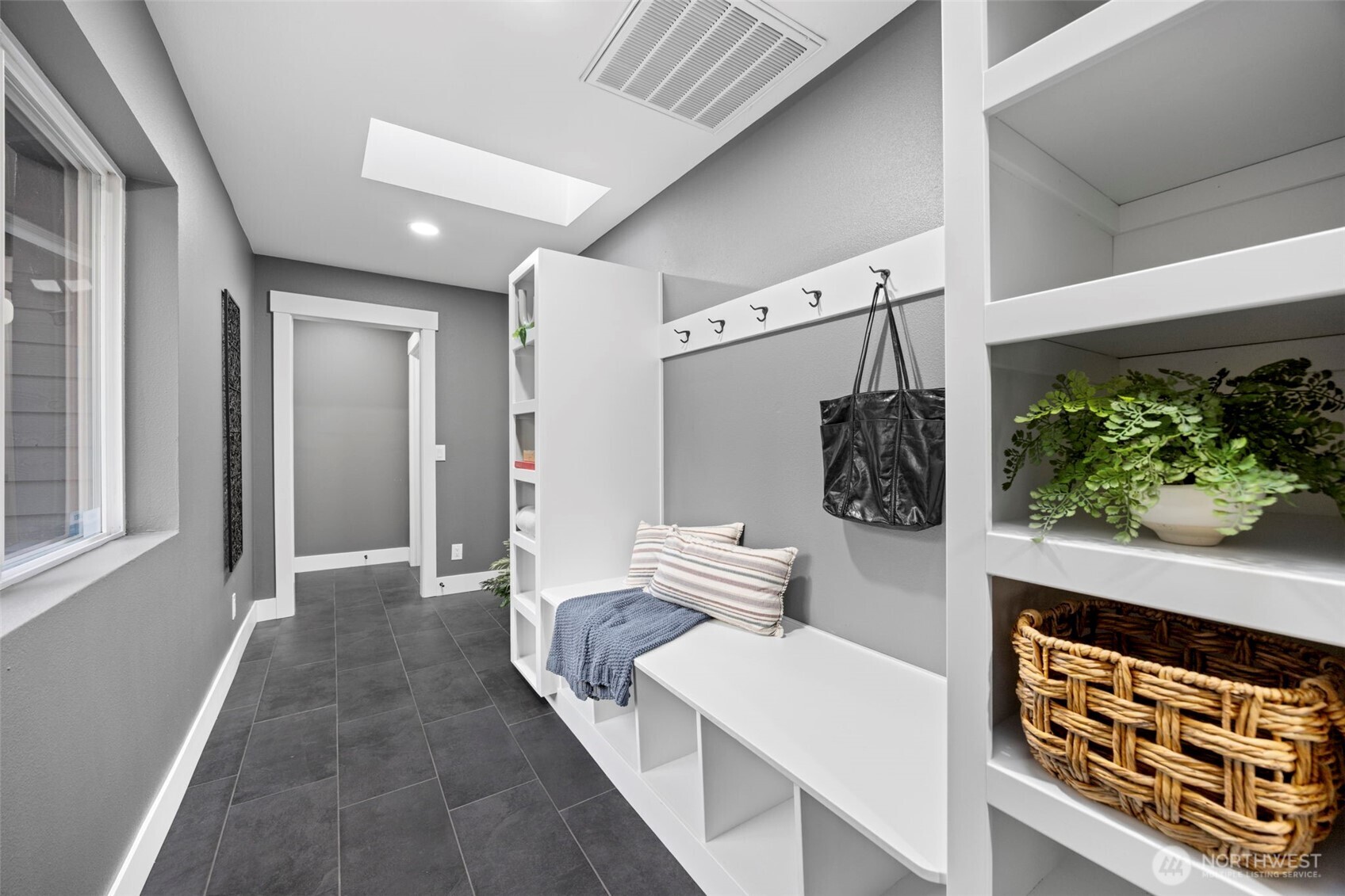 9371 Willamette Meridian Road Northwest Silverdale, WA 98383 - Photo 29 of 40 a hallway with a white stove top oven a potted plant and a wooden floor
