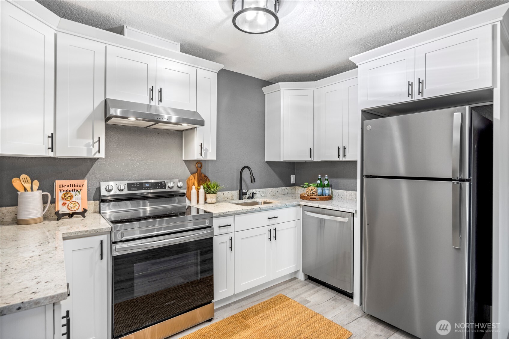 9371 Willamette Meridian Road Northwest Silverdale, WA 98383 - Photo 31 of 40 a kitchen with stainless steel appliances a refrigerator sink and cabinets