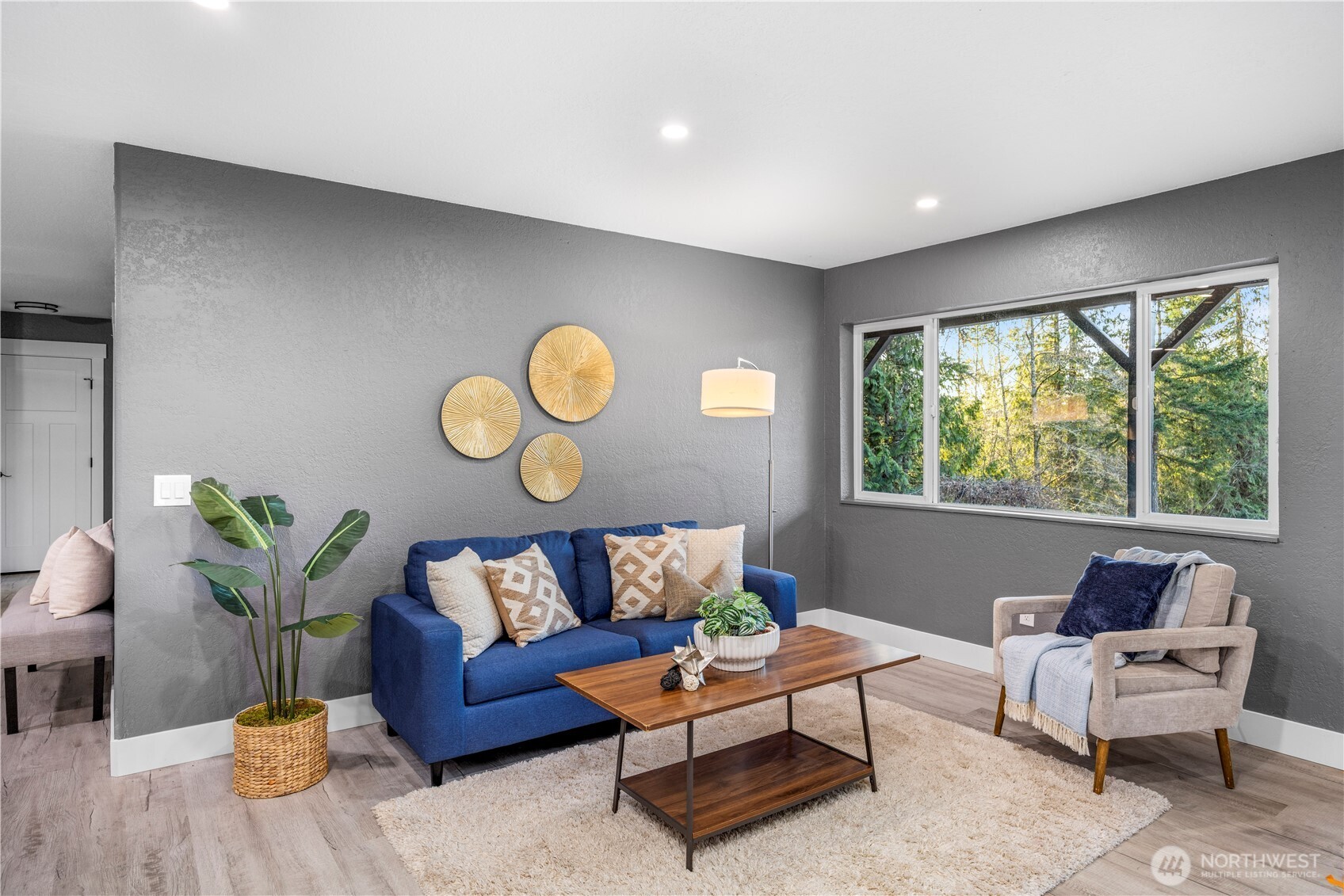 9371 Willamette Meridian Road Northwest Silverdale, WA 98383 - Photo 34 of 40 a living room with furniture and a large window