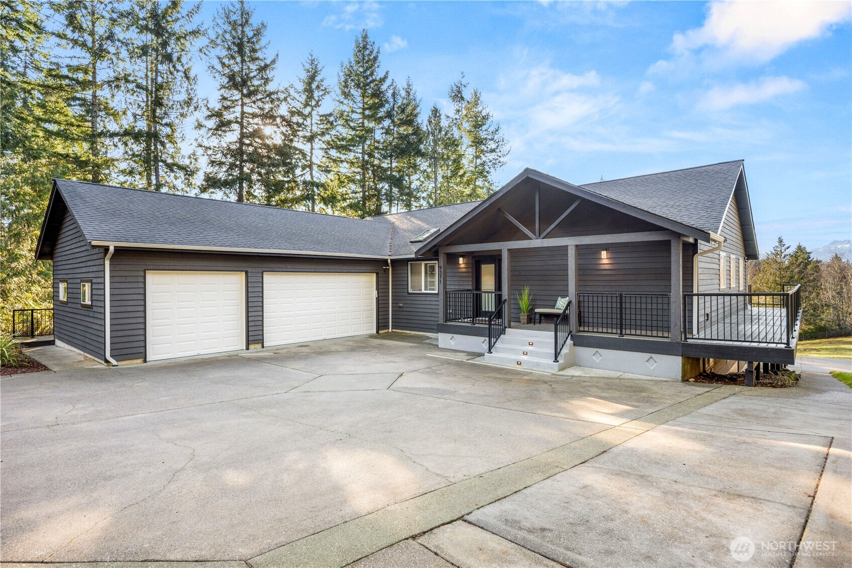 9371 Willamette Meridian Road Northwest Silverdale, WA 98383 - Photo 5 of 40 a view of a house with a patio and a yard