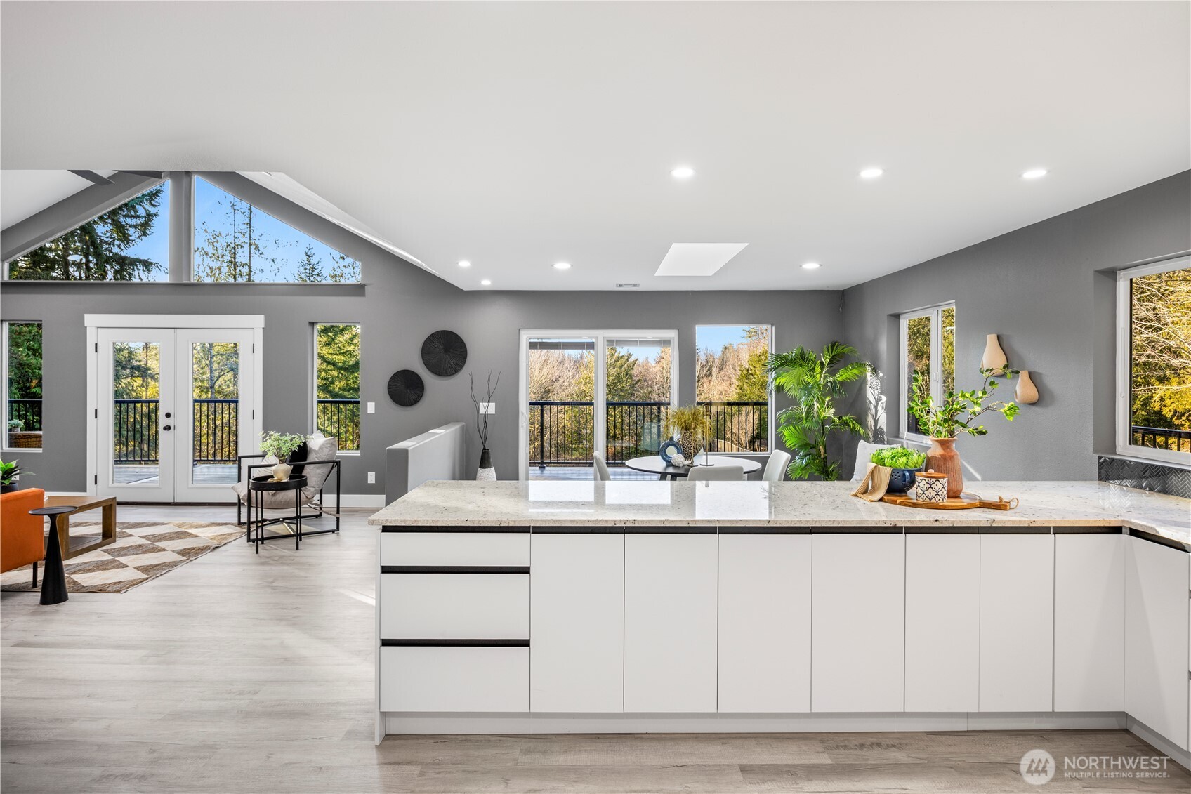 9371 Willamette Meridian Road Northwest Silverdale, WA 98383 - Photo 8 of 40 a living room with kitchen island furniture and a large window