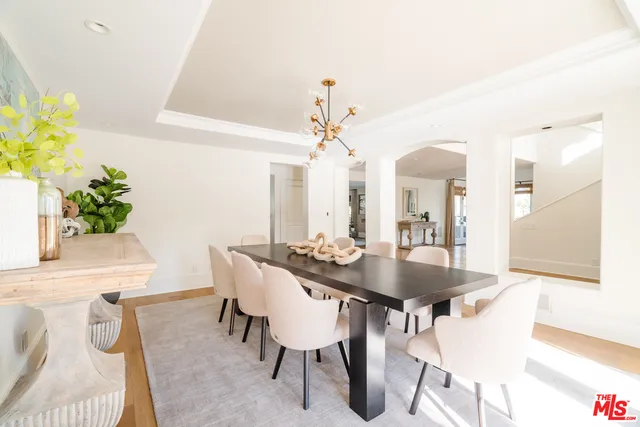 a view of a a dining room with furniture and a potted plant