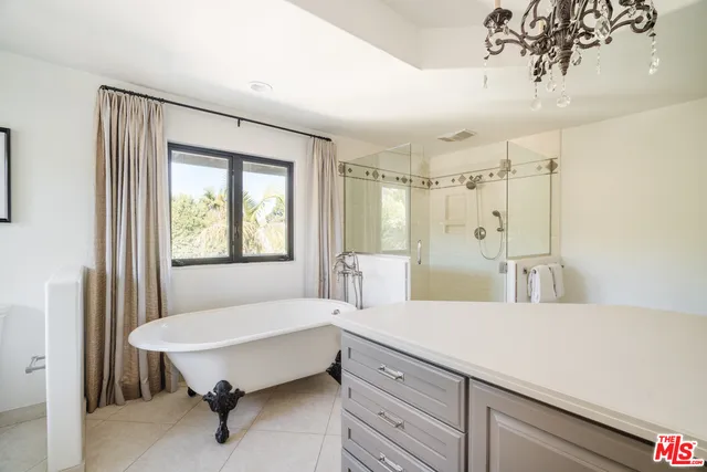 a spacious bathroom with a double vanity sink and a bathtub