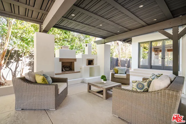 a outdoor living space with furniture and fireplace