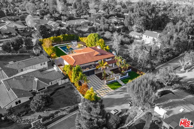 an aerial view of a house with a swimming pool