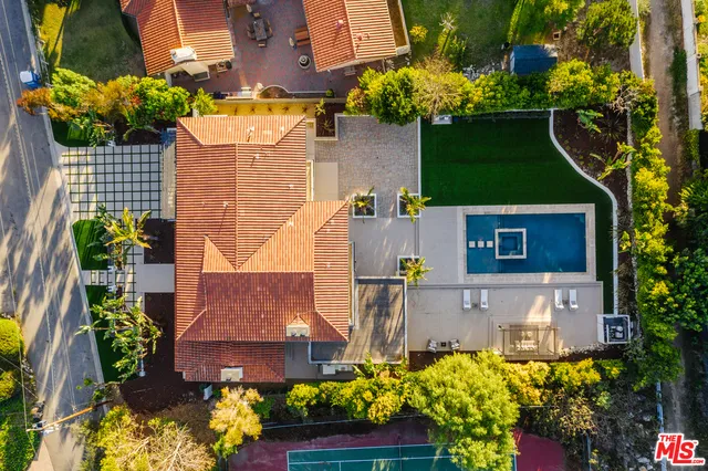 a front view of a house with a yard and fountain
