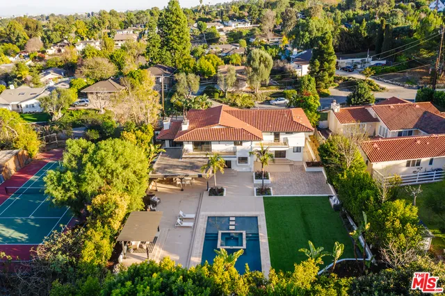an aerial view of multiple houses with yard
