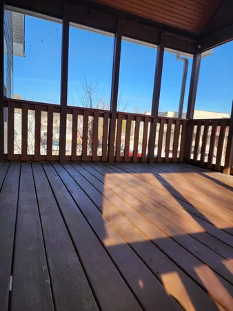 a view of a balcony with wooden floor