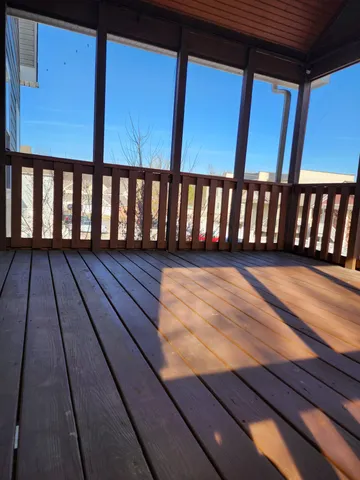 a view of a balcony with wooden floor