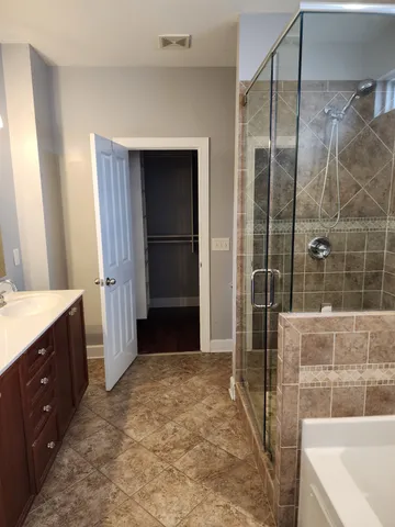a bathroom with a tub and a shower