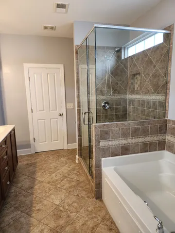a bathroom with a bathtub and a shower