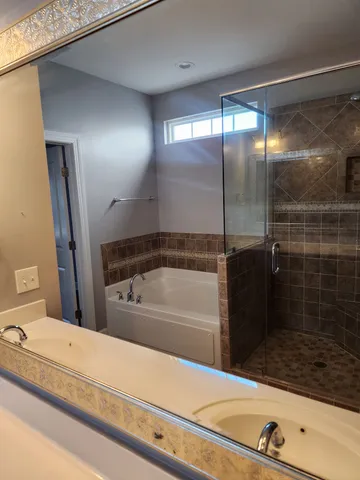 a bathroom with a tub and a shower