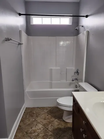 a view of kitchen with refrigerator sink and a open cabinets