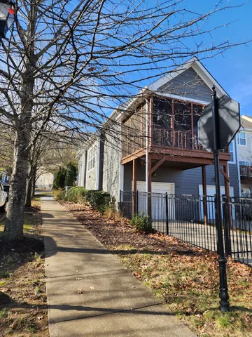 a view of a house with a wooden fence