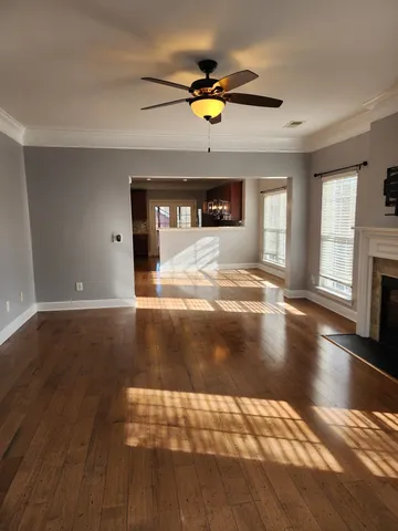 a view of living room with fireplace and wooden floor