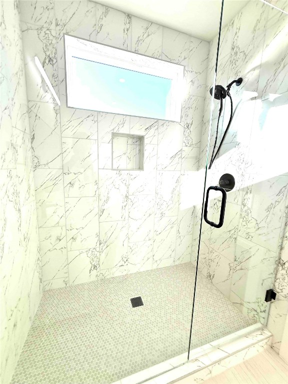 6809 Porter Street, Unit A Austin, TX 78741 - Photo 15 of 23 Bathroom featuring a marble finish shower