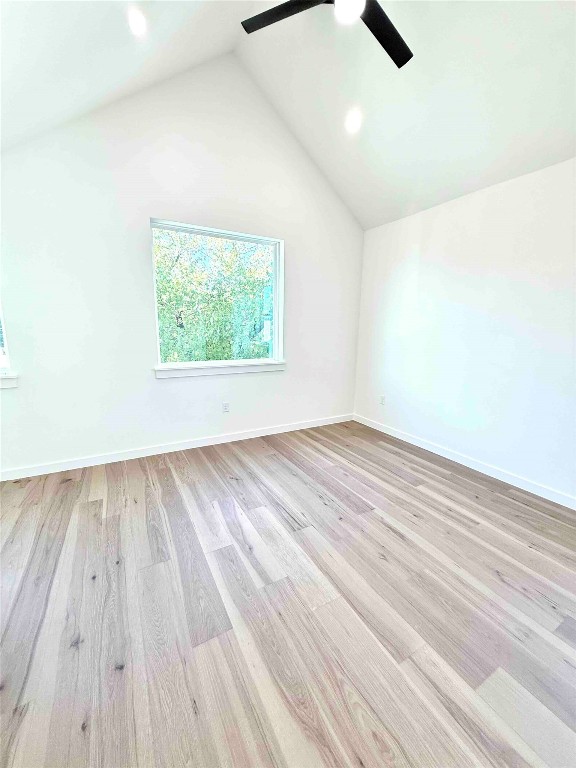 6809 Porter Street, Unit A Austin, TX 78741 - Photo 17 of 23 Unfurnished room with light wood-style flooring, high vaulted ceiling, ceiling fan, and recessed lighting