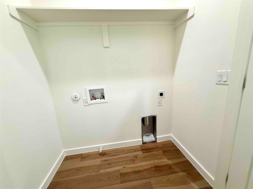 6809 Porter Street, Unit A Austin, TX 78741 - Photo 19 of 23 Washroom featuring washer hookup, dark wood finished floors, gas dryer hookup, and hookup for an electric dryer