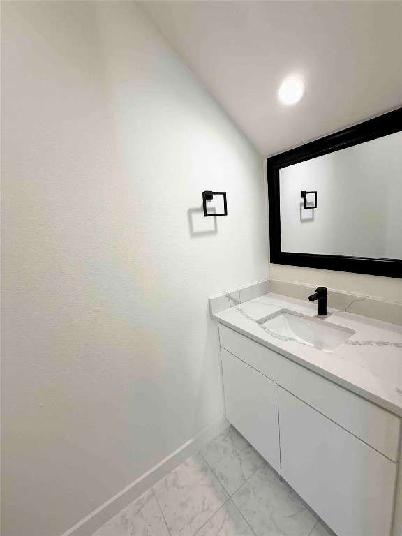 6809 Porter Street, Unit A Austin, TX 78741 - Photo 6 of 23 Bathroom featuring vanity, light marble finish flooring, and recessed lighting