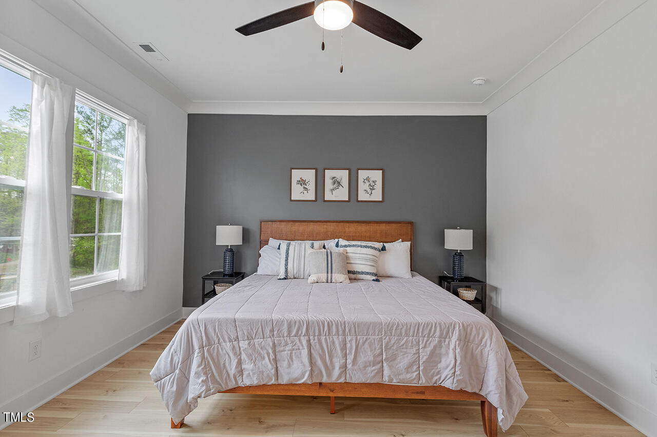 6504 Brecken Pnes Court Raleigh, NC 27612 - Photo 23 of 36 a bedroom with a large bed and a large window