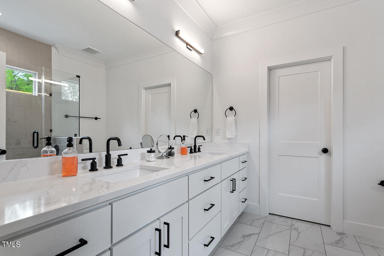 6504 Brecken Pnes Court Raleigh, NC 27612 - Photo 24 of 36 a bathroom with double sink and a mirror