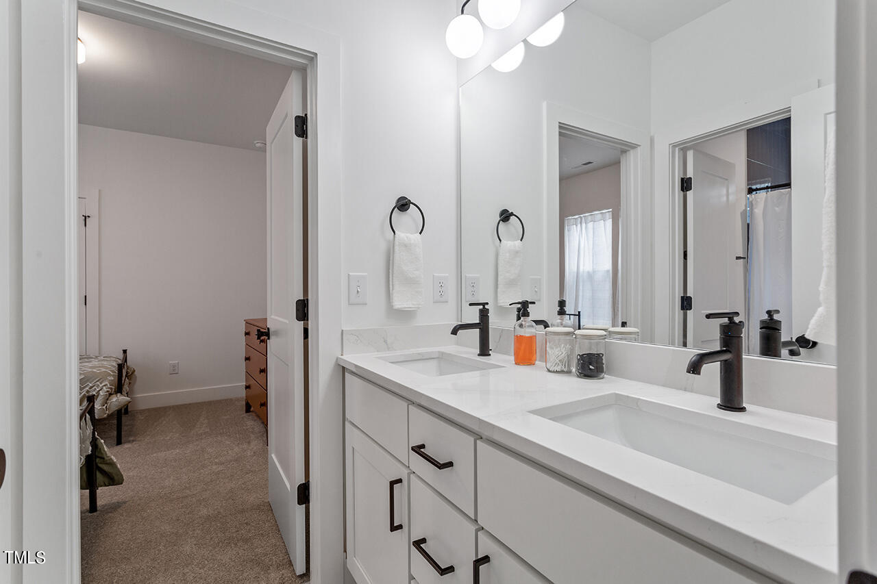 6504 Brecken Pnes Court Raleigh, NC 27612 - Photo 29 of 36 a bathroom with a sink and a mirror