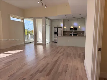 a view of living room with furniture and wooden floor