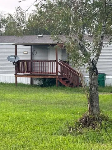 a view of a wooden deck with a yard
