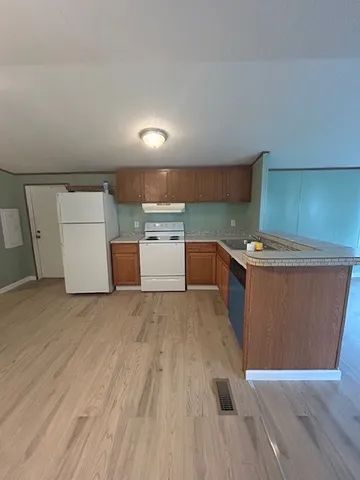 a room with wooden floor and storage