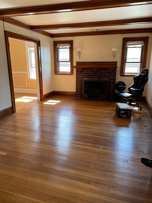 257 Common Street, Unit 2 Watertown, MA 02472 - Photo 12 of 30 a living room with furniture and a fireplace