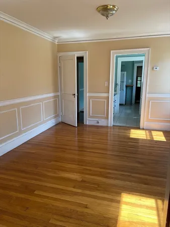 wooden floor in a hall with an empty room
