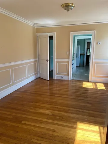 wooden floor in a hall with an empty room