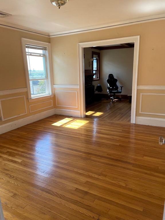 257 Common Street, Unit 2 Watertown, MA 02472 - Photo 17 of 30 a view of a livingroom with wooden floor and furniture