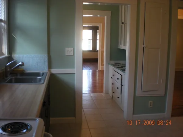 a view of a room with wooden floor