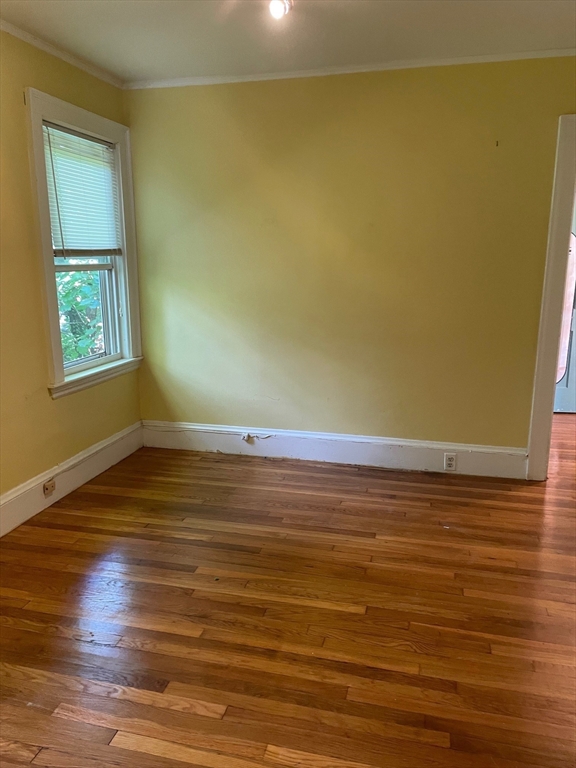 257 Common Street, Unit 2 Watertown, MA 02472 - Photo 21 of 30 an empty room with wooden floor and windows