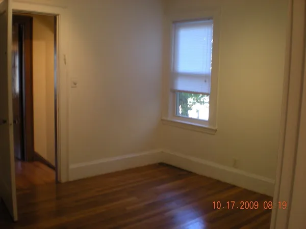 a view of a room with wooden floor and a sink