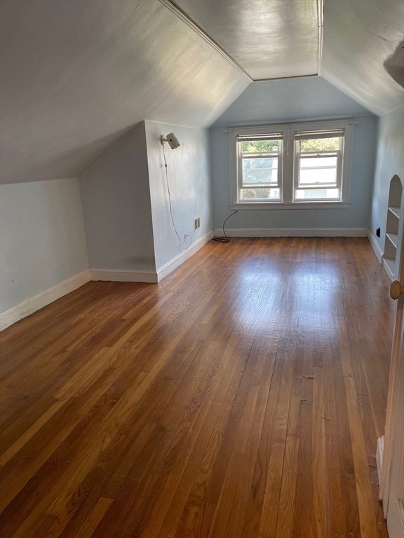 257 Common Street, Unit 2 Watertown, MA 02472 - Photo 26 of 30 an empty room with wooden floor and windows