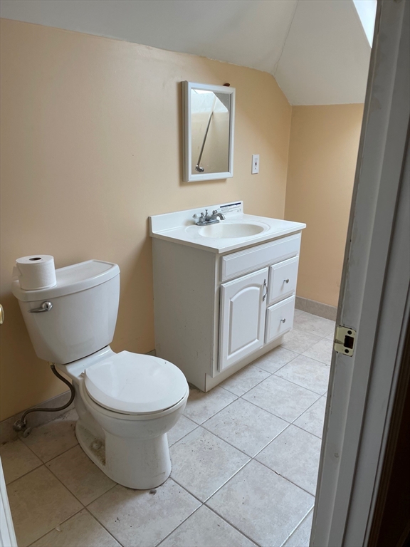 257 Common Street, Unit 2 Watertown, MA 02472 - Photo 27 of 30 a bathroom with a toilet sink and mirror