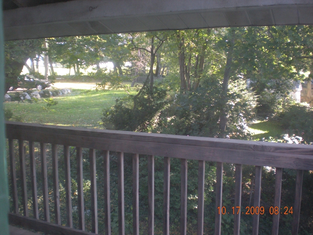 257 Common Street, Unit 2 Watertown, MA 02472 - Photo 30 of 30 a wooden fence with yard in back