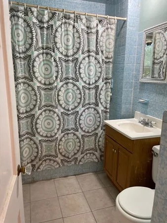 a bathroom with a sink and mirror with toilet